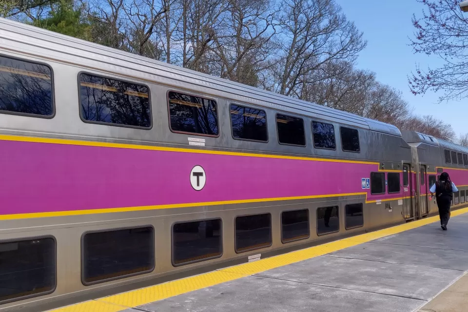 Silver commuter train with purple stripe in Boston, Massachusetts